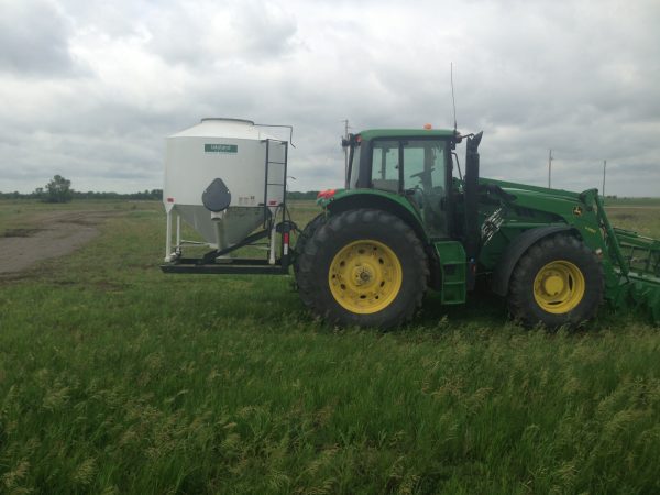 95 Bushel Easy Feeder in White Color on Tractor in Field